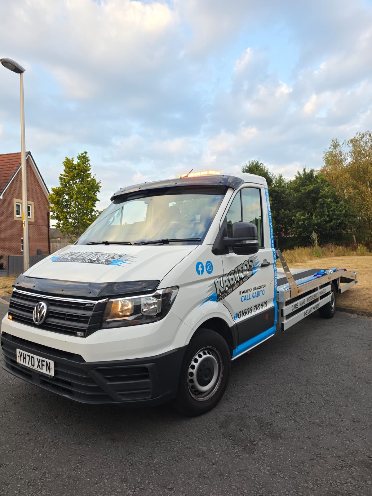 Kabito's flatbed recovery truck with amber beacon lights